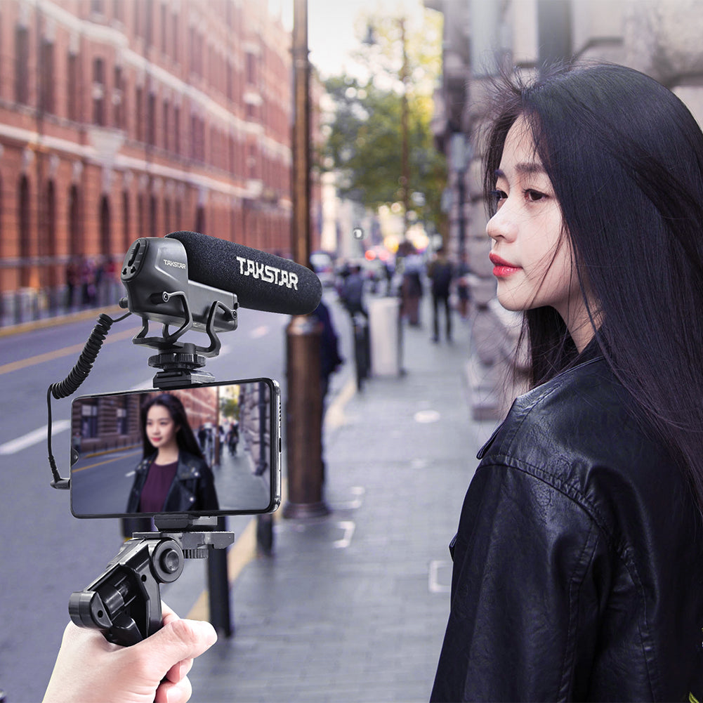 Takstar SGC-600 Shotgun Camera Microphone mounted on a selfie stick and connected to a smart phone