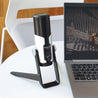 Takstar GX6 Desktop USB Condenser Microphone on a table next to a laptop