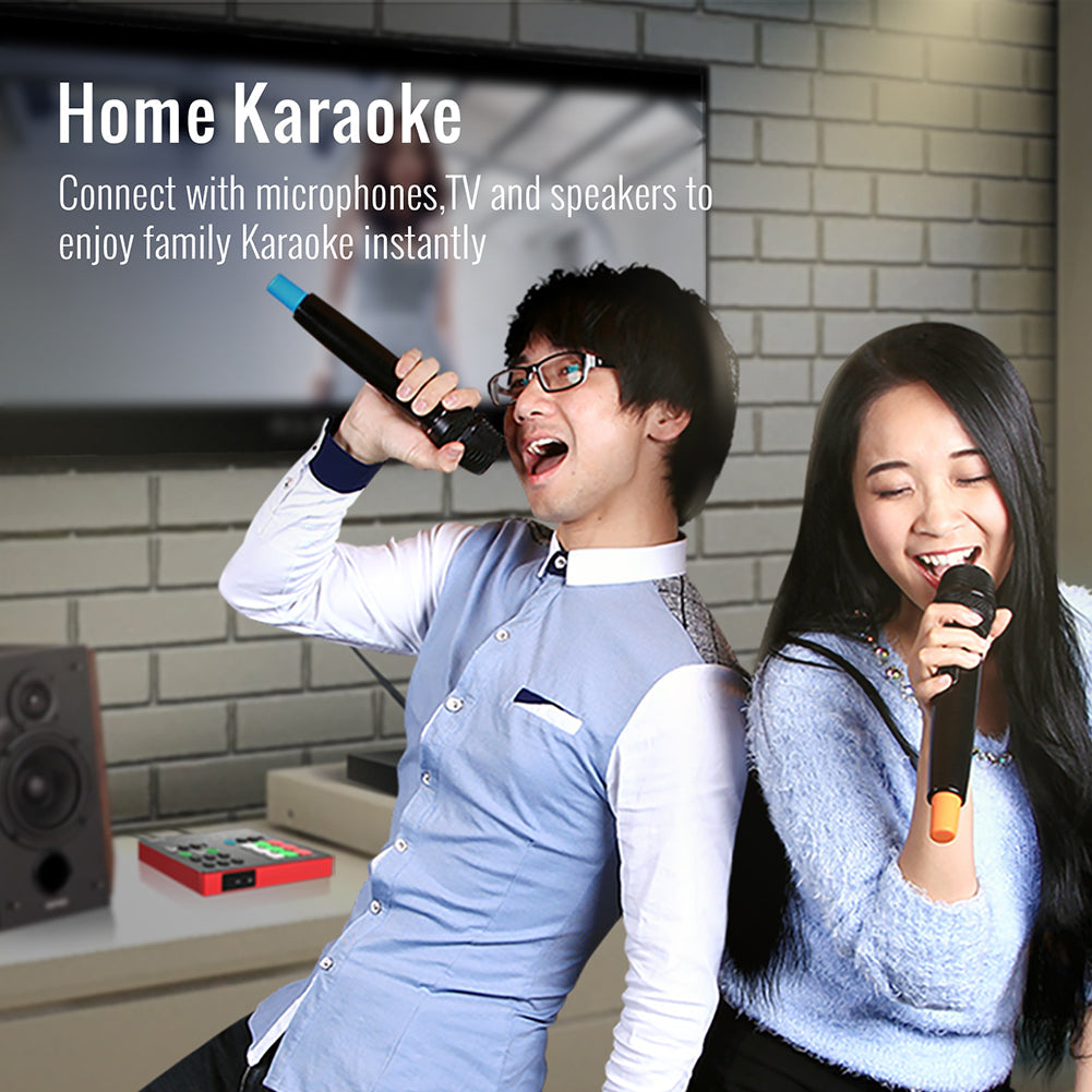 A man and a women is connecting Takstar SC-M1 Portable Livestream sound card with two wireless microphones, a TV and two speakers for home Karaoke