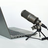 Takstar SM-8B Studio Recording Condenser Microphone mounted on a tripod connected to a laptop