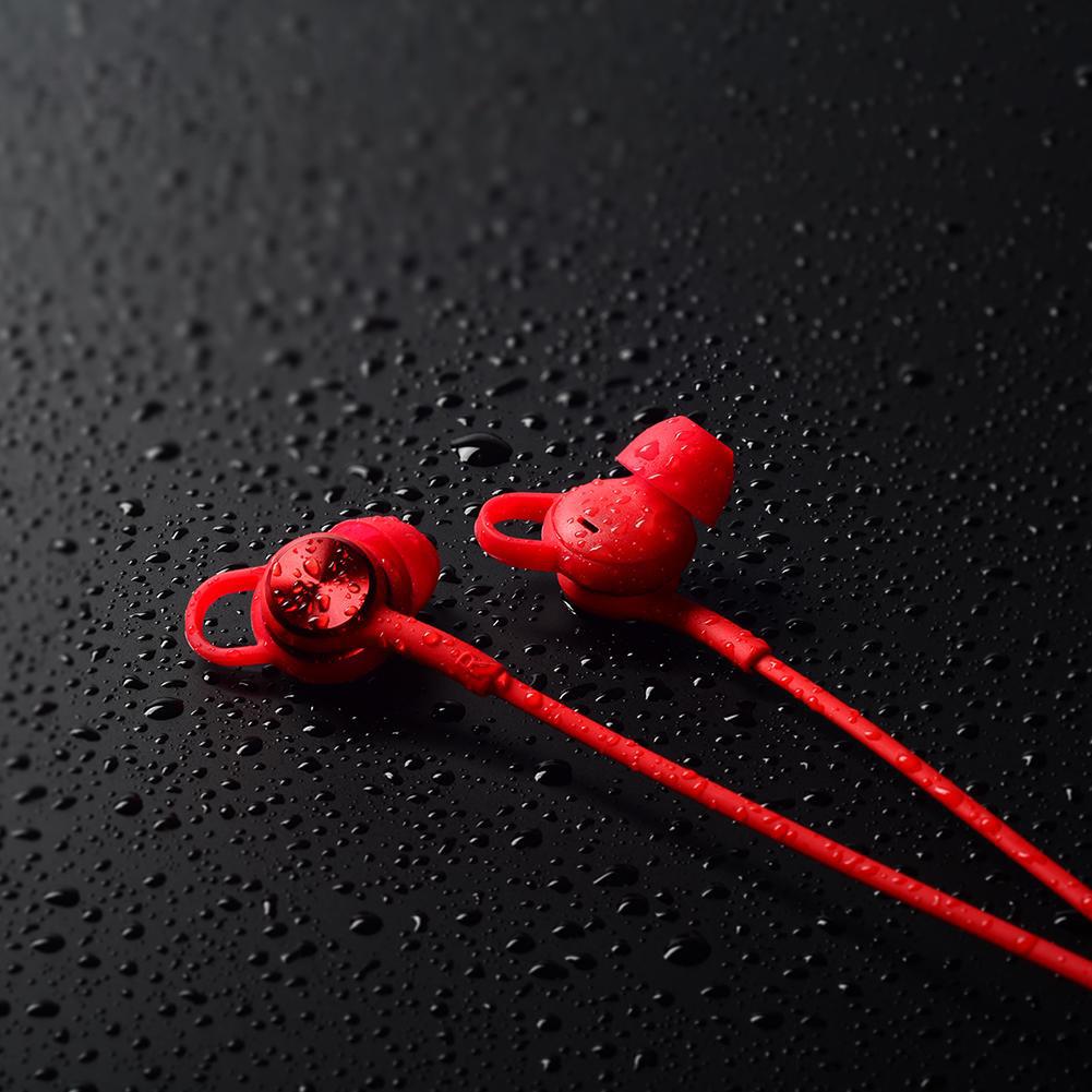 Takstar AW1 Bluetooth Sports Earphone red amidst water sprinkles