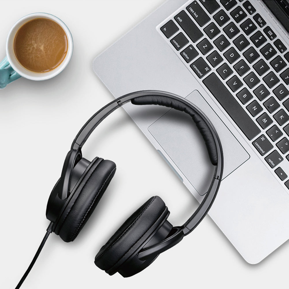 Takstar TS-450 Dynamic Stereo Monitor Headphones next to a laptop and a cup of coffee